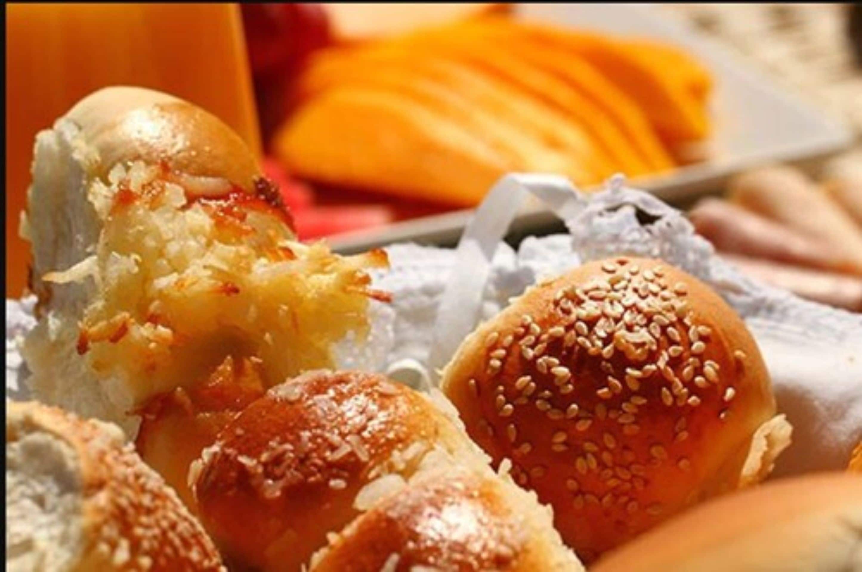 A variety of baked goods, including bread rolls and pastries.