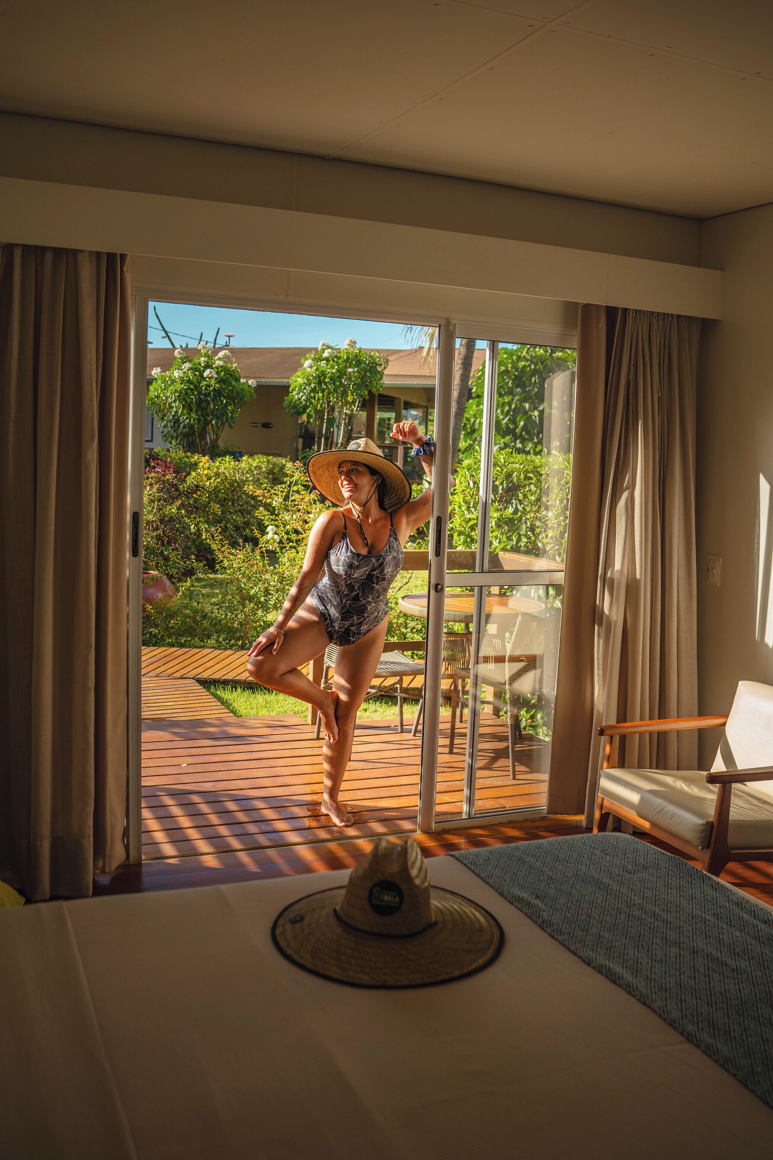 A room with a large sliding glass door leading to an outdoor deck.