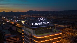 A high-rise hotel with a prominent sign reading "CROWNE PLAZA" at the top. - Crowne Plaza Kayseri by IHG (Kayseri)