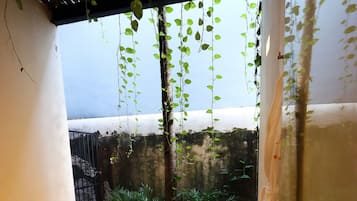 Habitación Deluxe, vista al jardín | Regadera en el baño