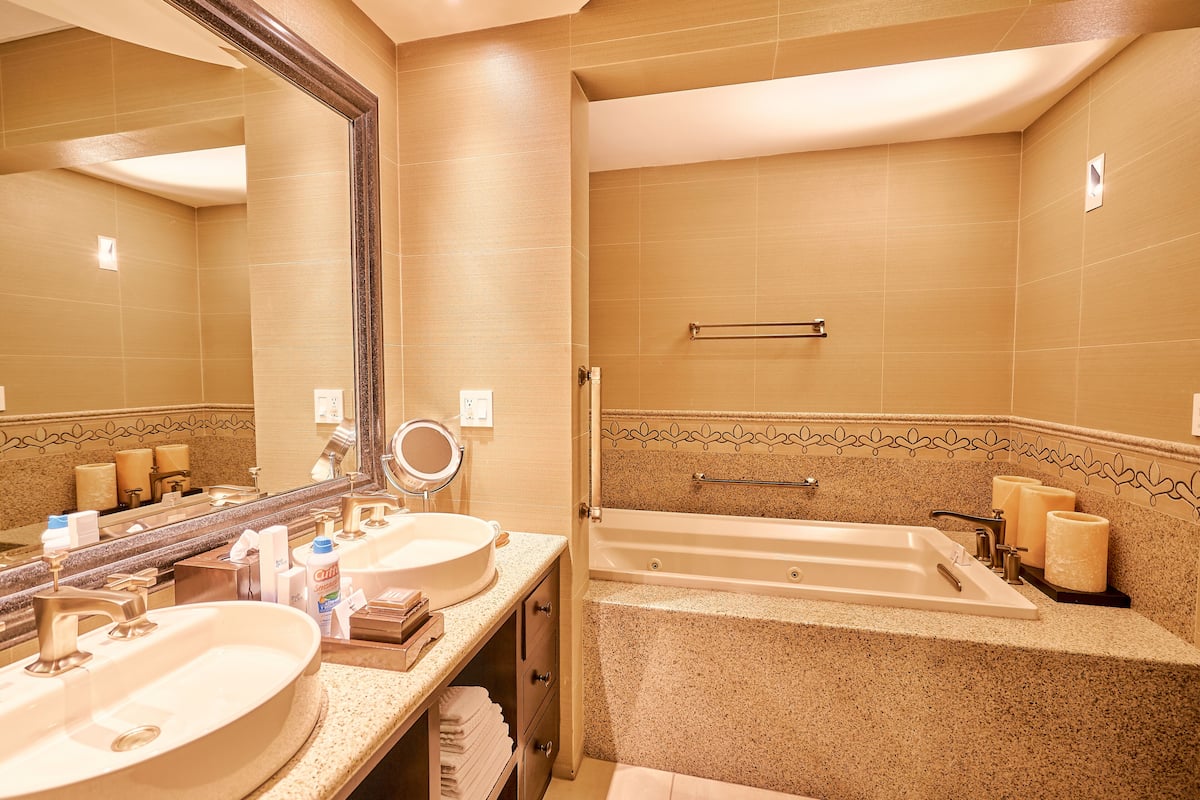 Separate tub and shower, rainfall showerhead, designer toiletries