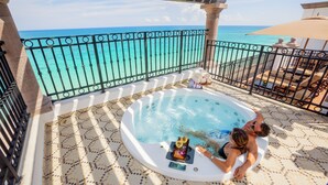 A couple relaxing in a hot tub with a view of the ocean. - Holiday Inn Club Vacations Grand Residences by IHG - All Inclusive (Puerto Morelos)