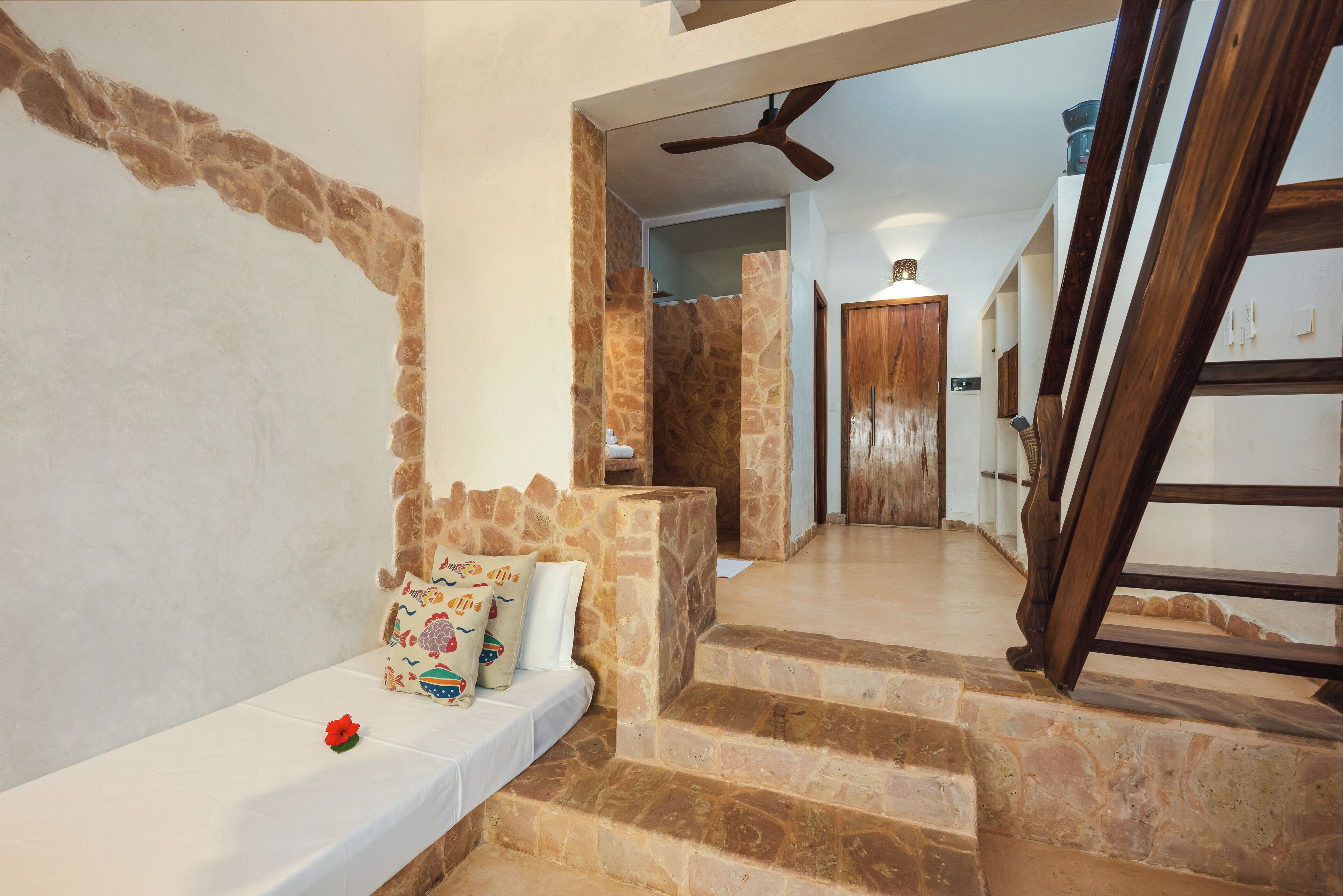 A staircase with stone steps leading to a wooden door.