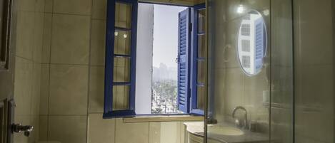 A bathroom with a toilet, bidet, and a glass shower enclosure.