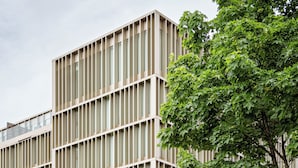 A modern building with a grid-like facade, large windows, and a tree in the foreground. - Crowne Plaza Vienna by IHG (Vienna)
