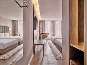A hotel room with two beds, a desk, and a chair. - Crowne Plaza Vienna by IHG (Vienna)