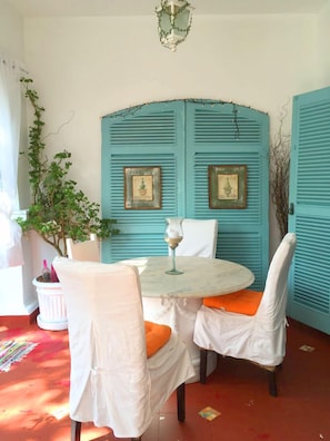 Enjoy meals for two at a cozy dining table with comfortable seating.