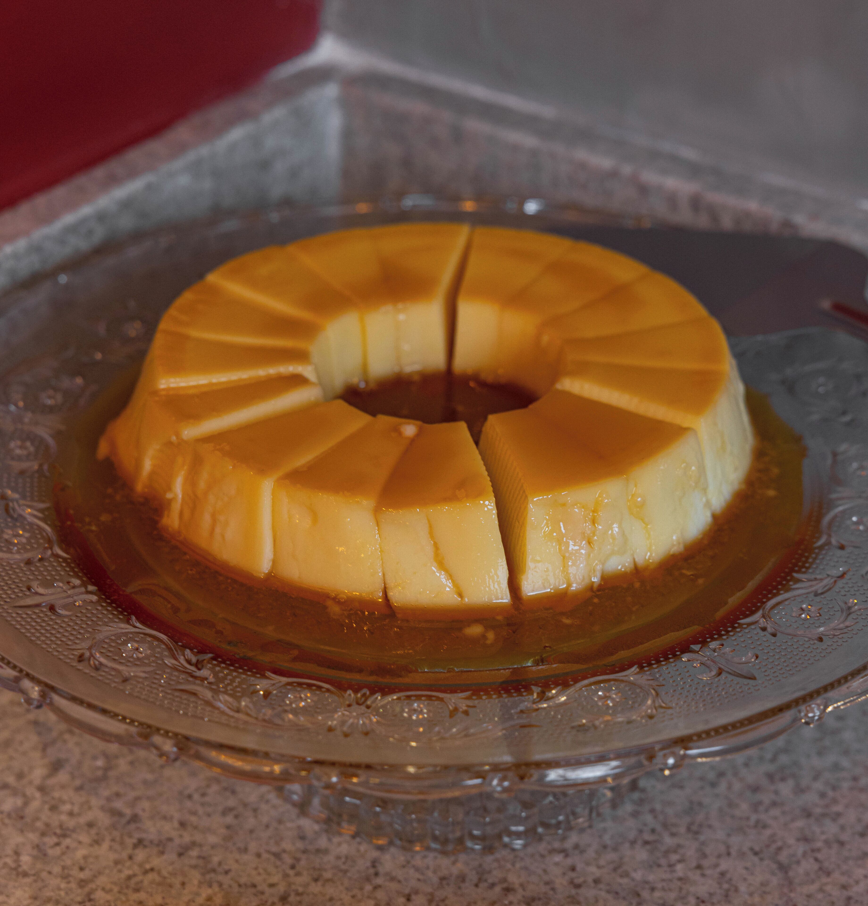 A caramel flan on a decorative glass plate.