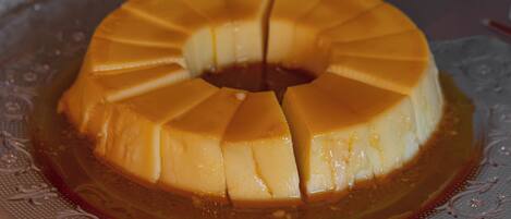 A caramel flan on a decorative glass plate.