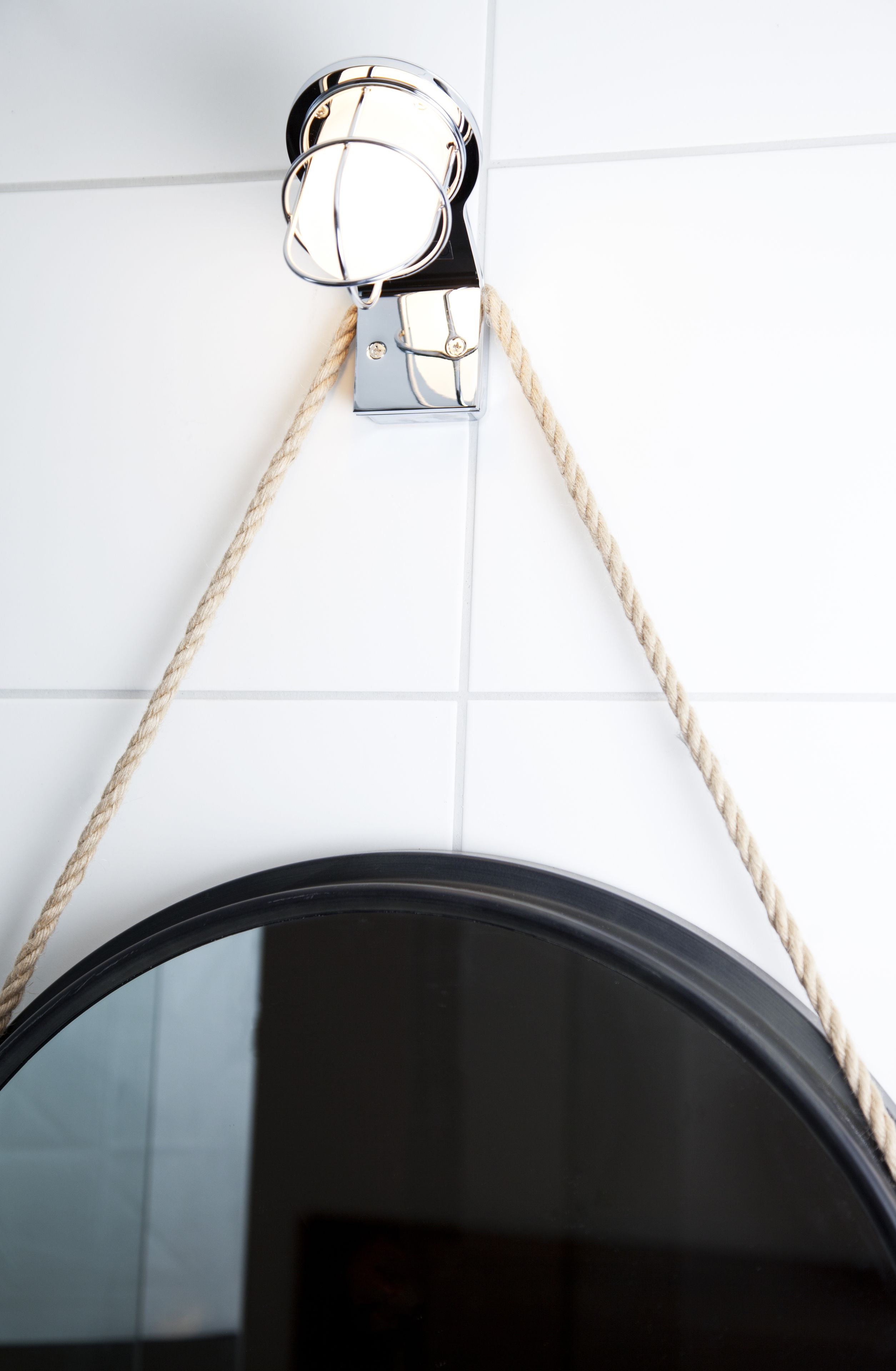 A ceiling-mounted pulley system with a rope.