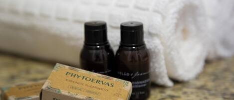 A bathroom with a white towel, two small bottles, and a box labeled 'PHYTOERVAS'.