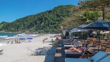 On the beach, sun-loungers, beach umbrellas, beach towels