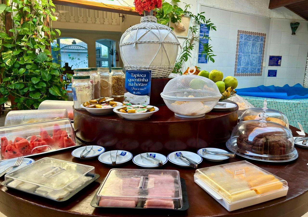 A buffet setup with various food items and a sign indicating a breakfast option.