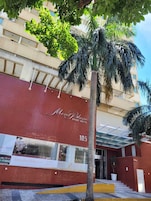 A hotel entrance with a red facade and the name 'MonBlanc Apart Hotel'.