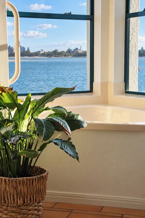 Ein Fenster mit Blick auf ein Gewässer und eine entfernte Skyline.