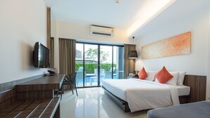 A modern hotel room with a large bed, a desk, and a television. - Hotel J Residence (Pattaya)