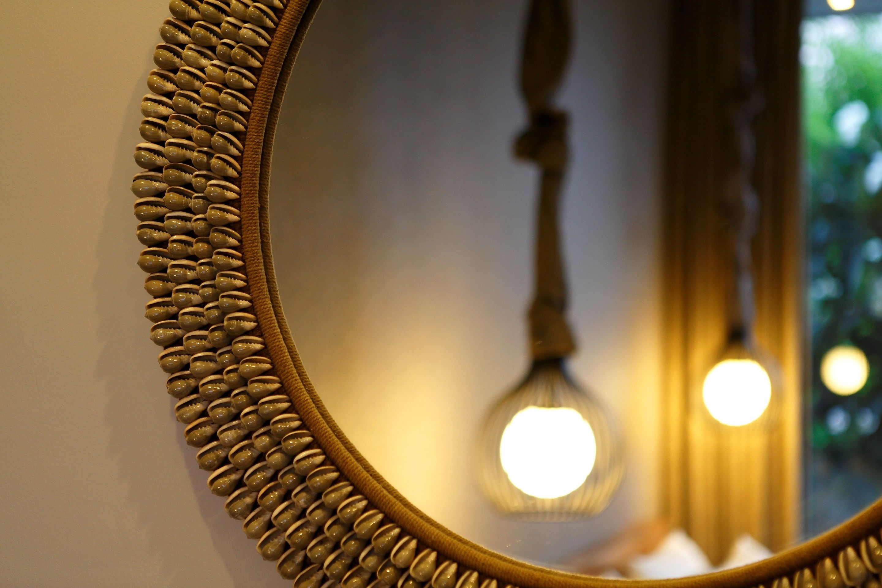 A close-up of a mirror with a textured frame.