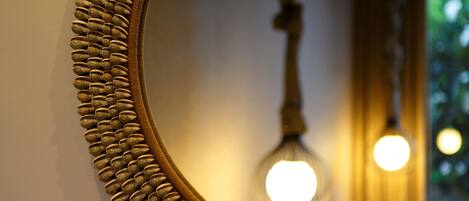 A close-up of a mirror with a textured frame.
