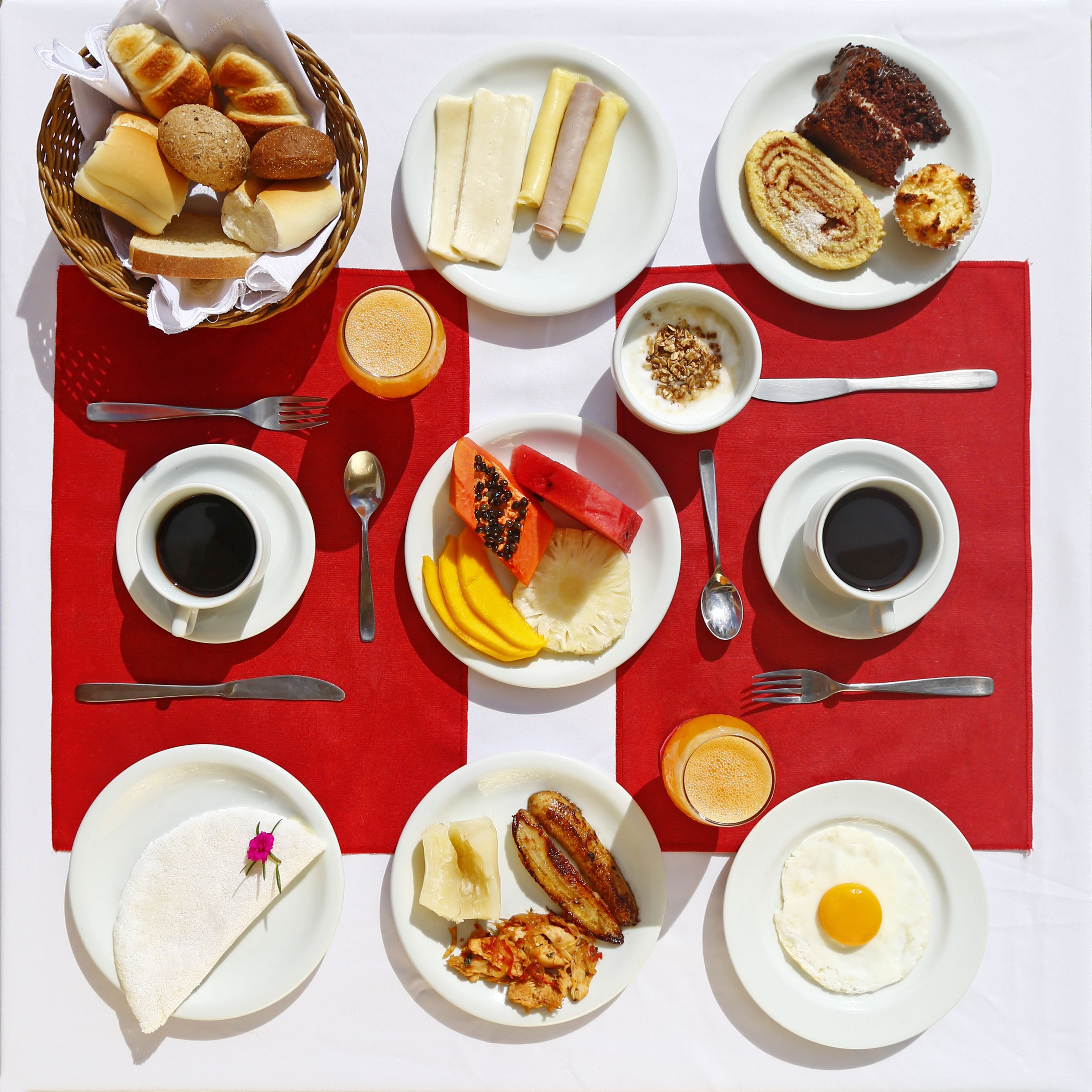 A breakfast spread with various dishes and beverages on a table.