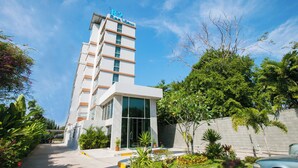 A modern hotel with a sign reading "B&B Sea View" on the top.
