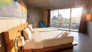 A hotel room with a large bed, a blue chair, and a view through the window. - B2 Sea View Pattaya Boutique & Budget Hotel (Sattahip)