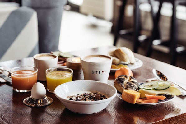 A breakfast table with various food items, including toast, eggs, and beverages. - STORY HOTEL STOCKHOLM NORTH, in JdV by Hyatt (Sundbyberg)