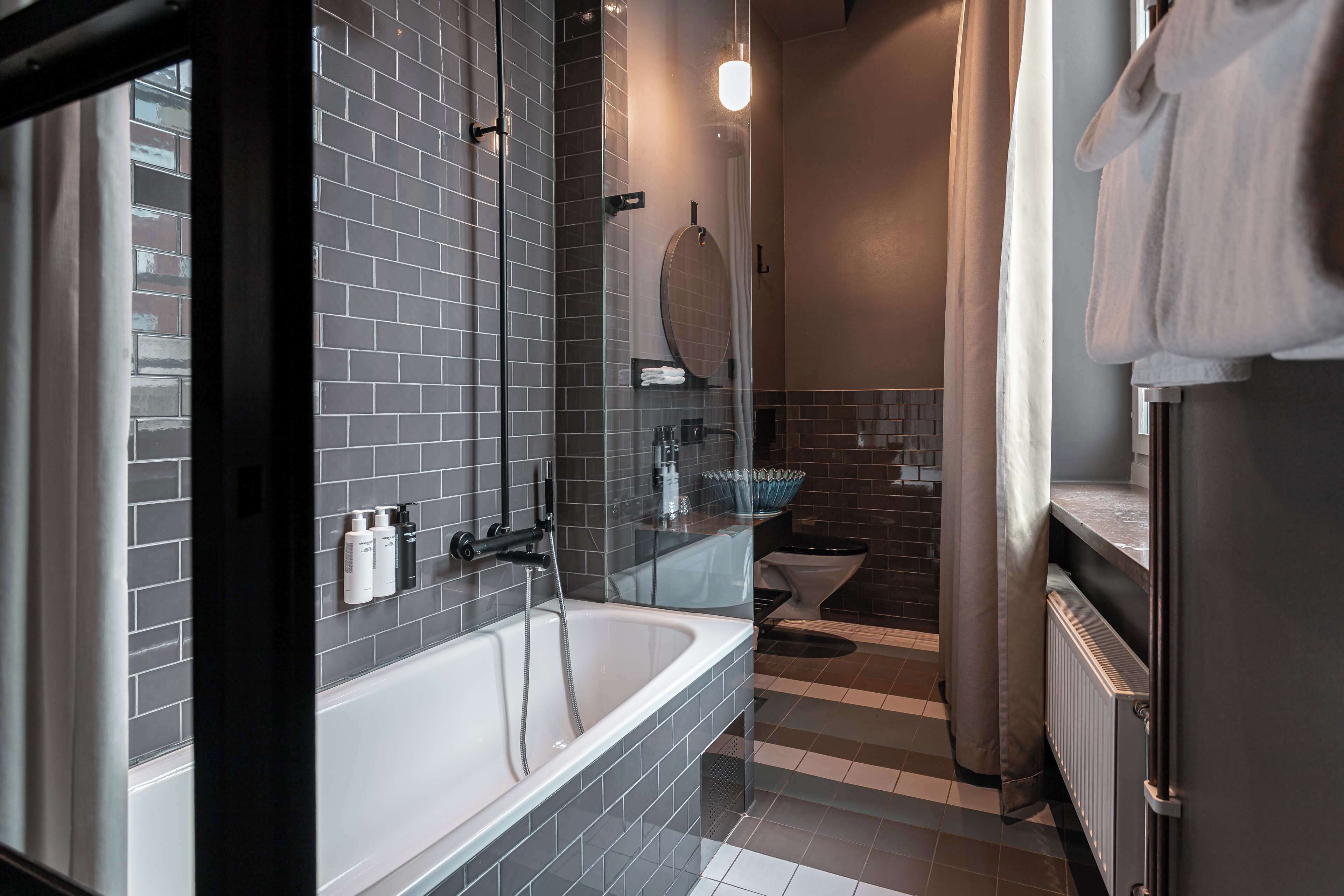 deluxe room, 1 queen bed | bathroom | designer toiletries, hair dryer, towels