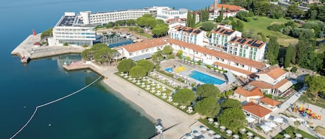 Una spiaggia nelle vicinanze, sabbia scura, lettini da mare, ombrelloni
