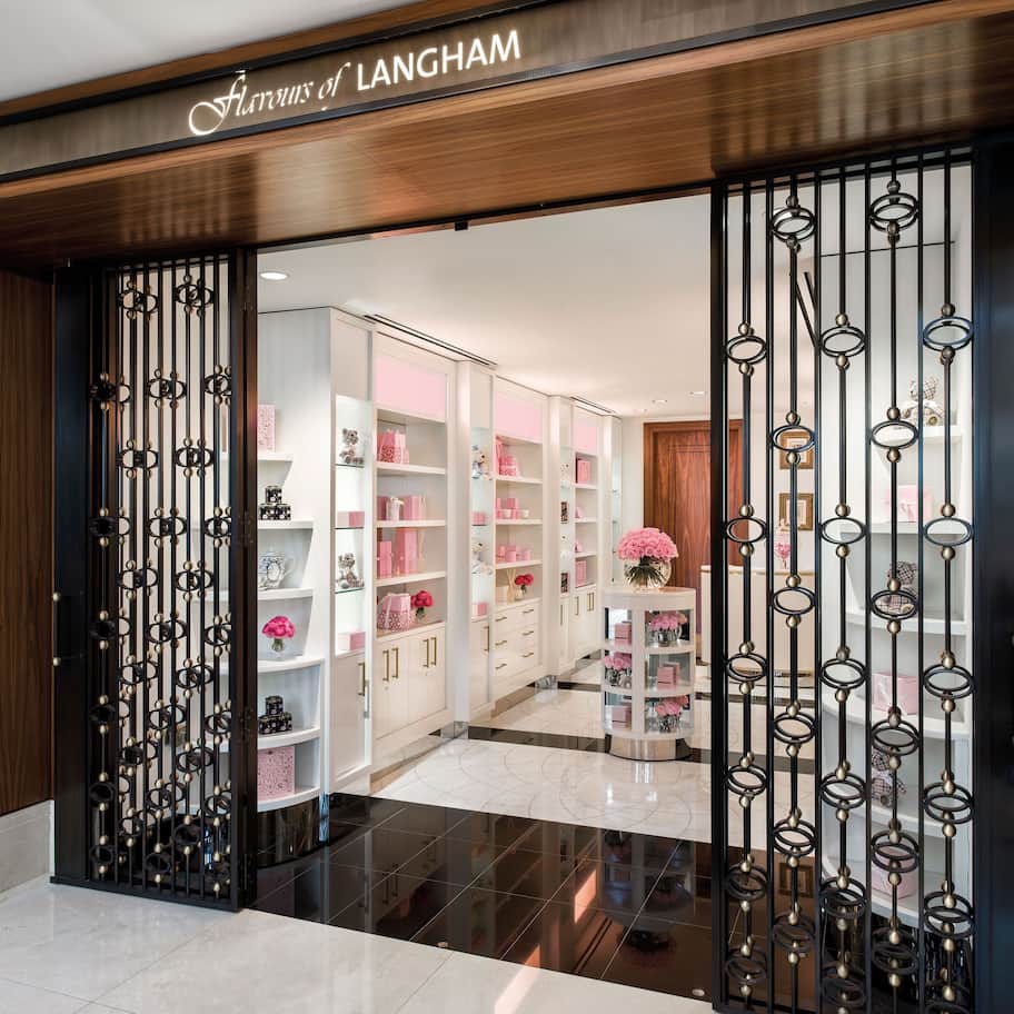 A store entrance with a wooden facade and a sign reading "Flavours of LANGHAM".