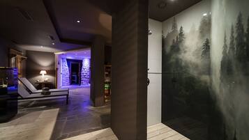 Relax in a serene space with a lounge chair and large screen displaying a forest scene.