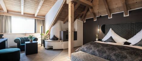 A modern bedroom with a large bed, a desk, and a sofa.