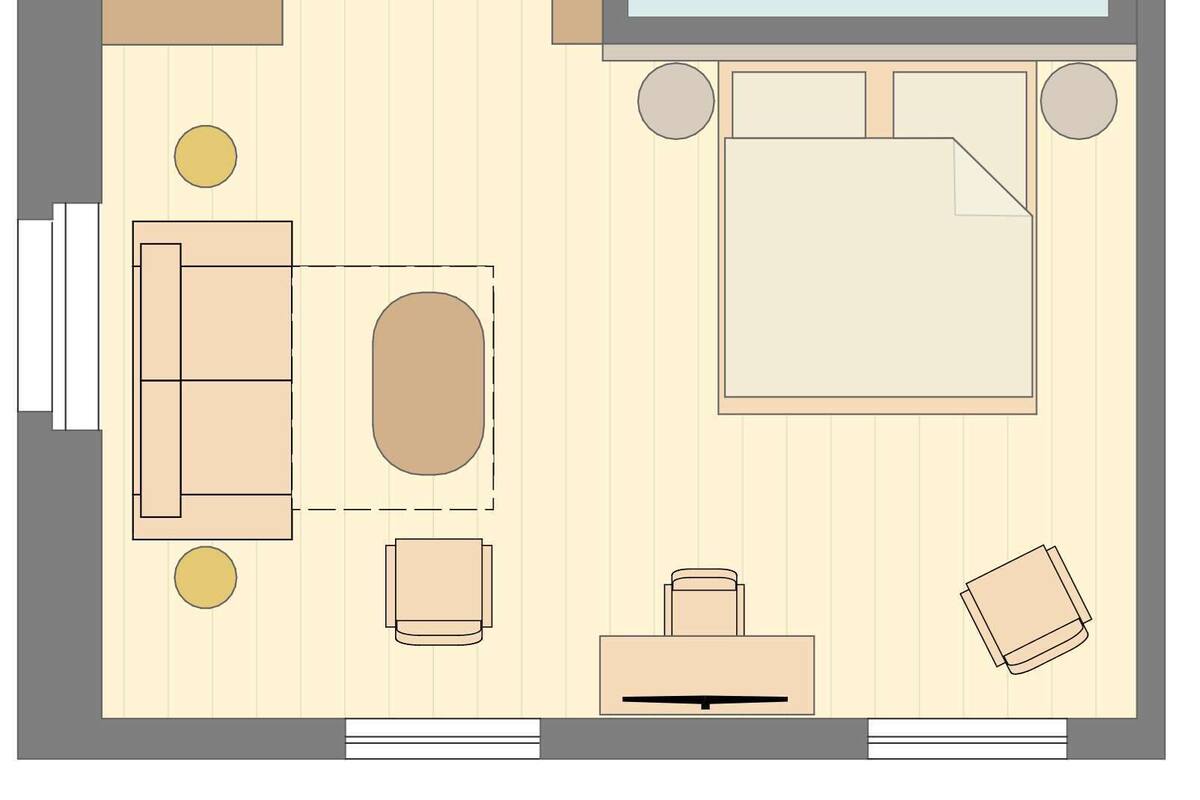 A hotel room layout with a bed, a desk, a chair, a sofa, a small table, and a bathroom.