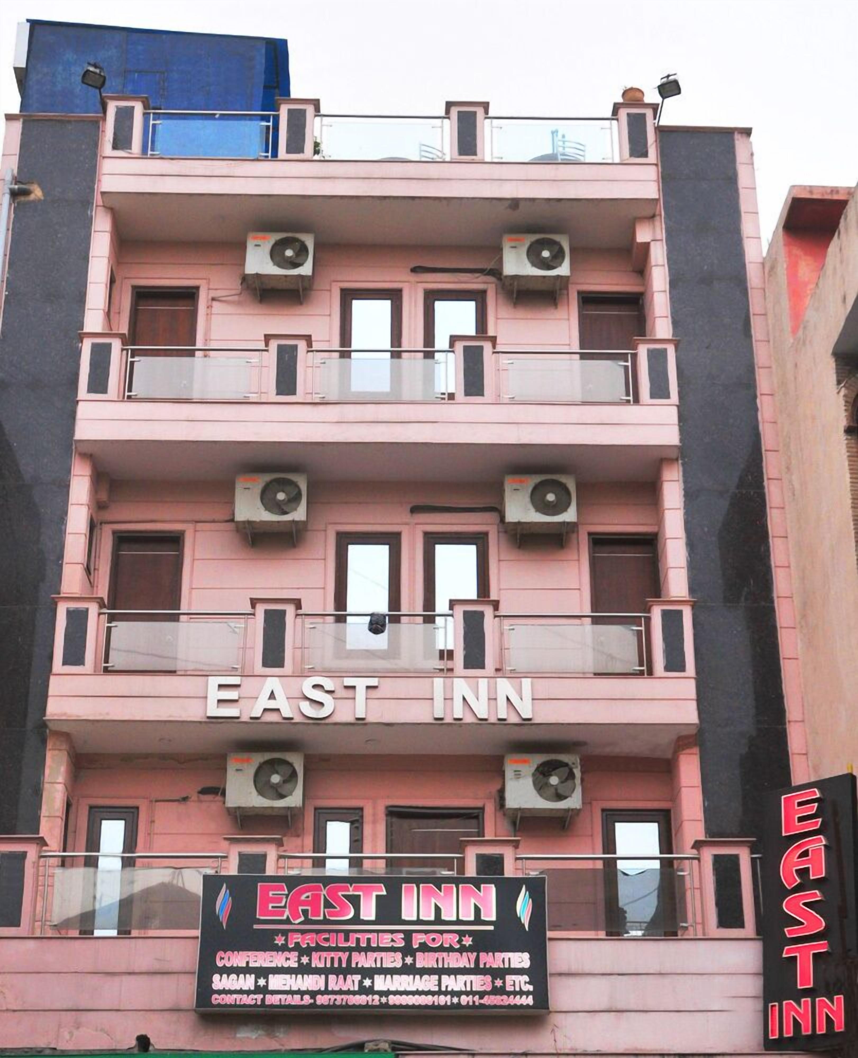 A multi-story building with the sign "EAST INN" on the facade.