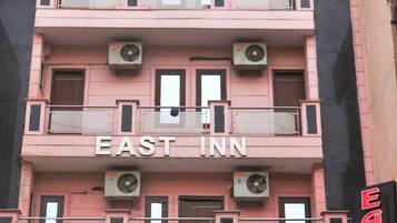 A multi-story building with the sign "EAST INN" on the facade.