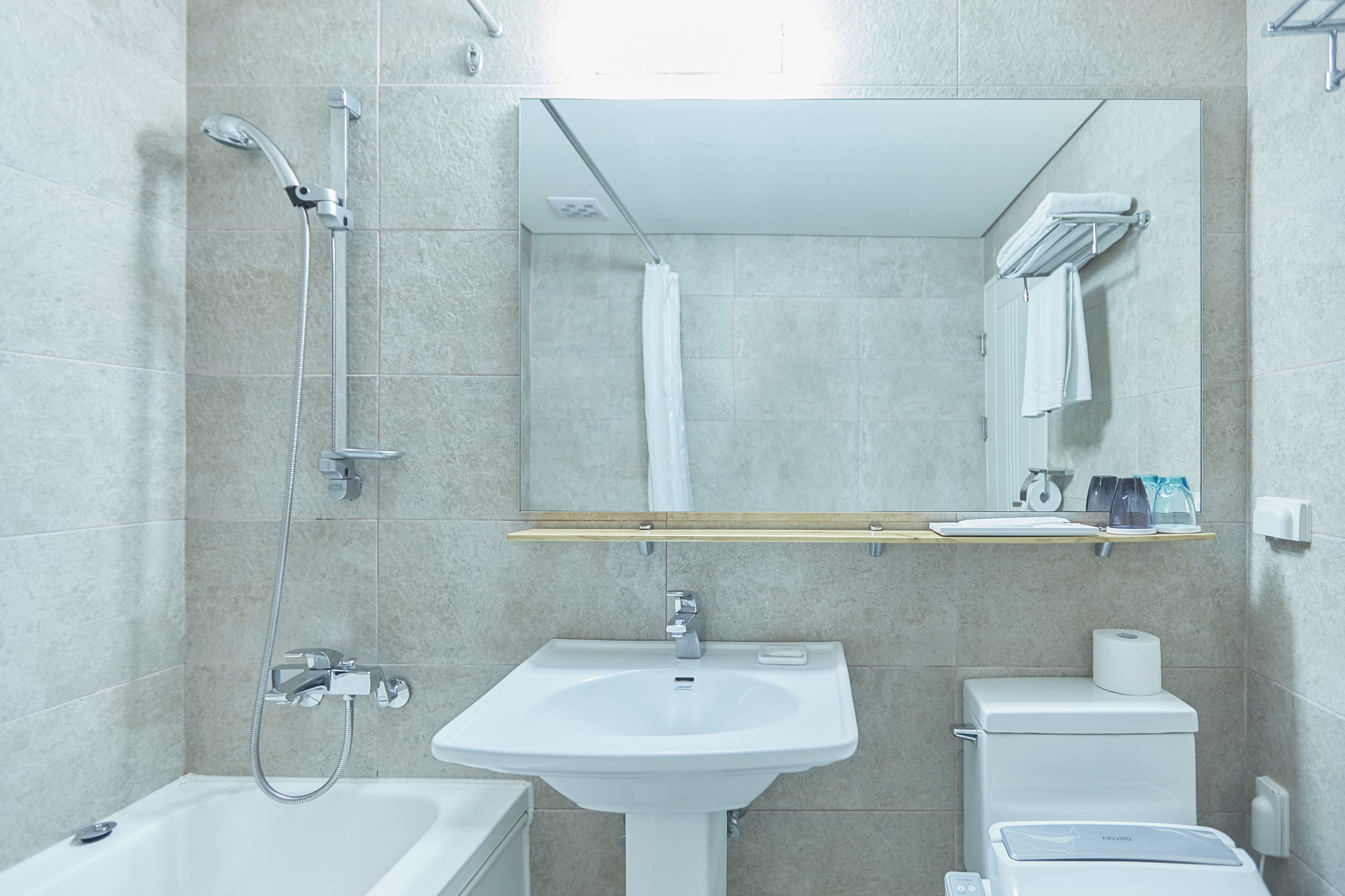 bathtub, hair dryer, slippers, bidet