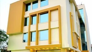 A modern building with a flat roof, large windows, and a checkered ground floor. - Royal View Hotel (Jaipur)