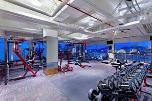 A gym with various exercise equipment, treadmills, and dumbbells. - Aston Jember Hotel and Conference Center (Jember)