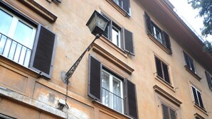 A building with a large wooden double door, multiple windows with shutters, and a visible elevator. - My Suites Piazza di Spagna (Rome)