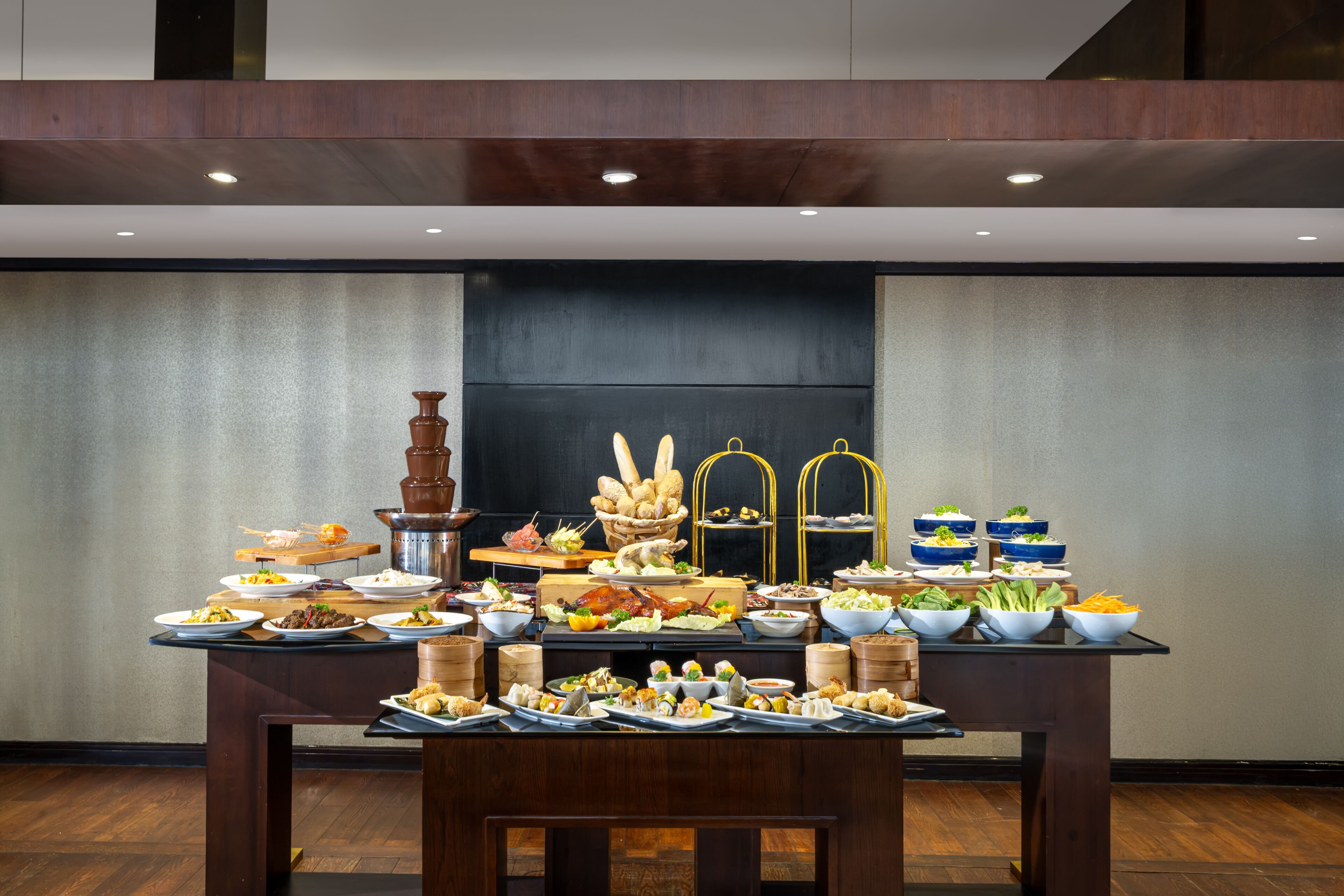 A buffet table with various dishes and a large urn.