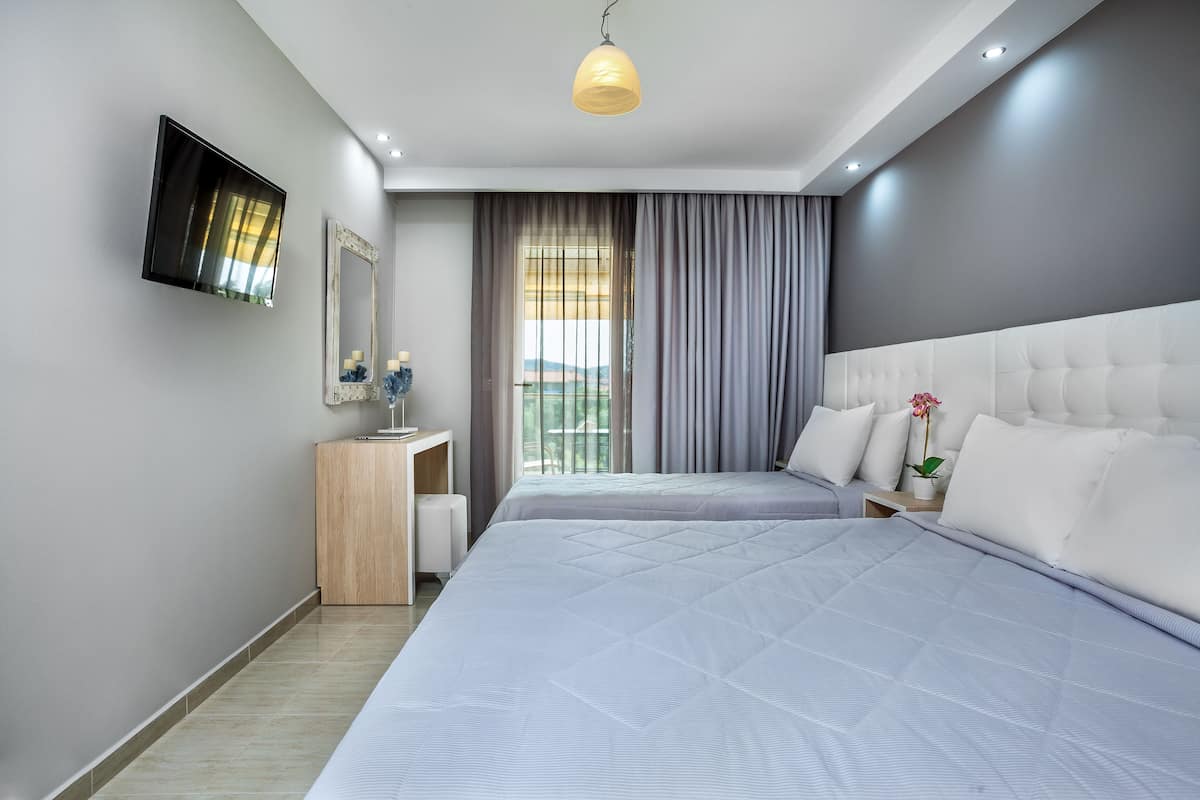Triple Room, Garden View | In-room safe, iron/ironing board, free cribs/infant beds, rollaway beds