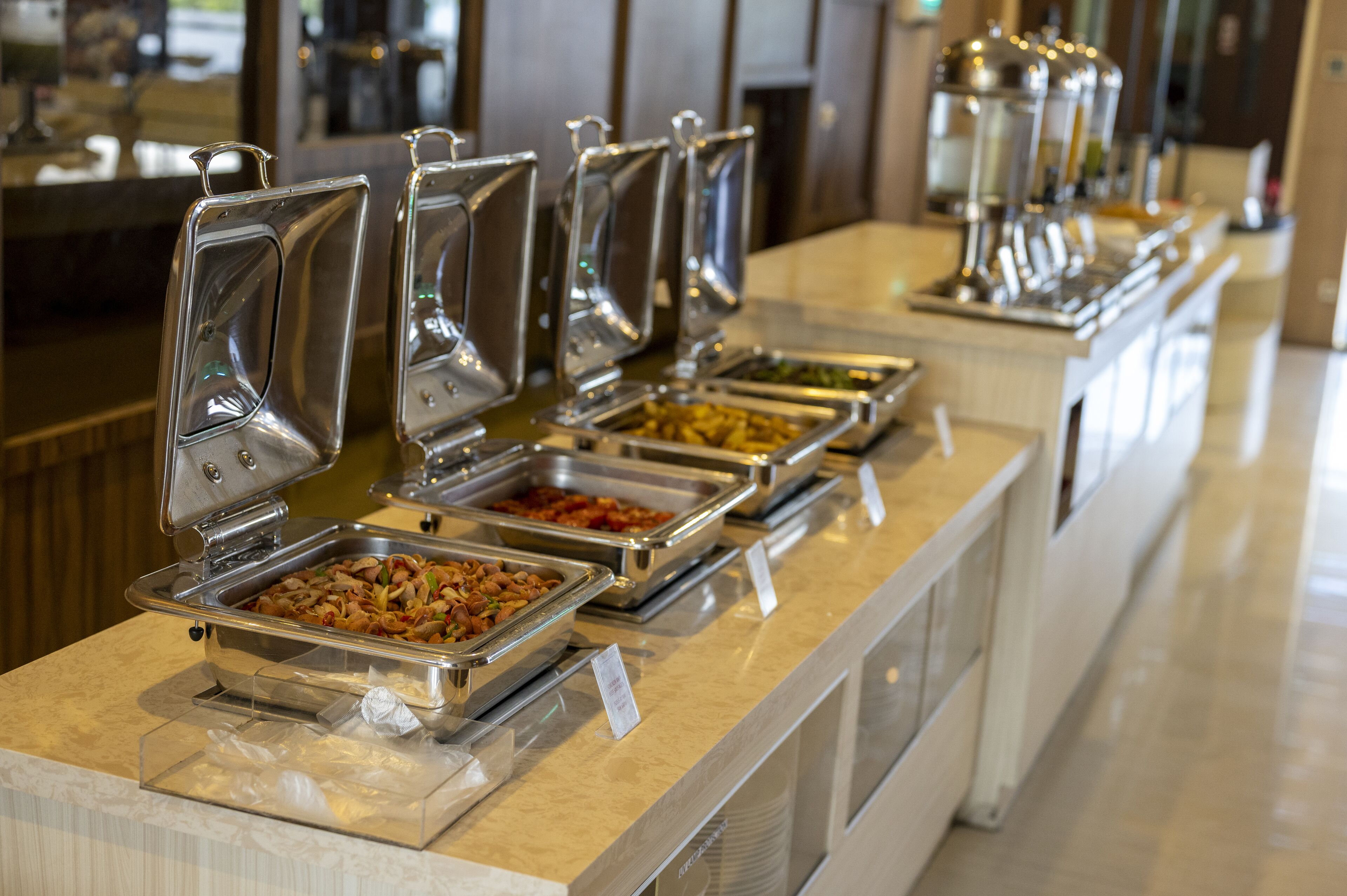 A buffet line with multiple food dispensers.
