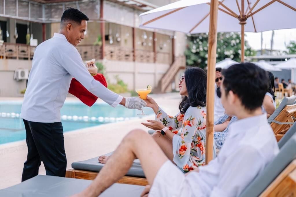 A poolside area with lounge chairs and umbrellas.