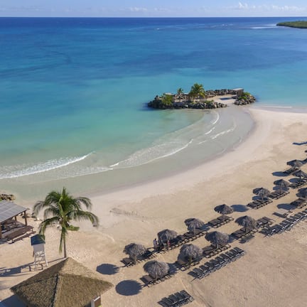 On the beach, white sand, free beach cabanas, sun loungers