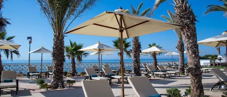 Indoor pool, outdoor pool, pool umbrellas, pool loungers