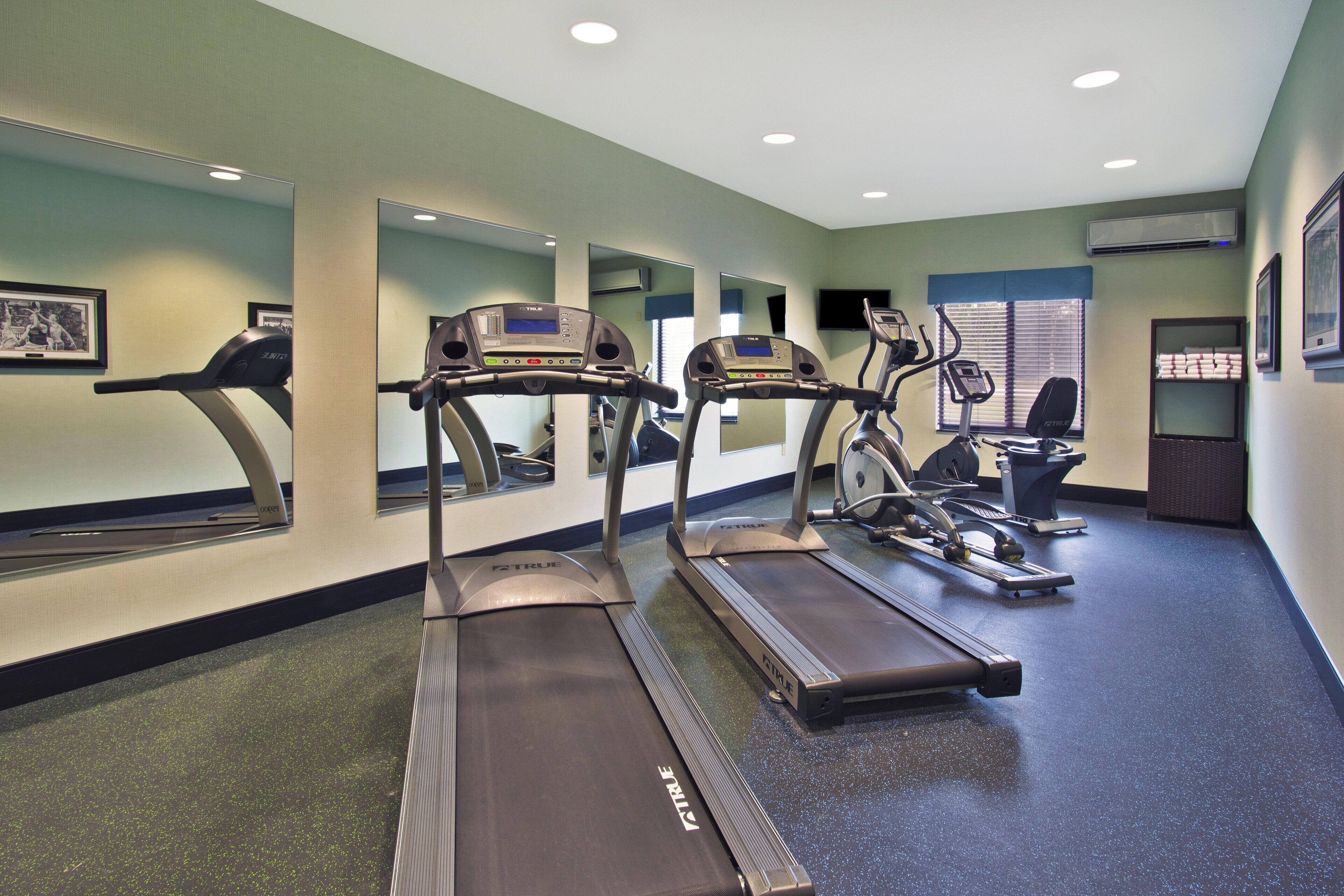 A fitness center with treadmills, a stationary bike, and a rowing machine.