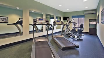 A fitness center with treadmills, a stationary bike, and a rowing machine.