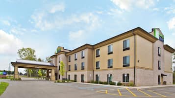 A Holiday Inn Express hotel with a covered entrance, parking lot, and brick facade.
