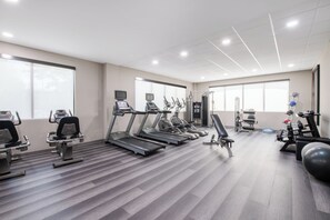 A modern gym with treadmills, elliptical machines, and free weights. - Staybridge Suites Atlanta Airport by IHG (Atlanta)