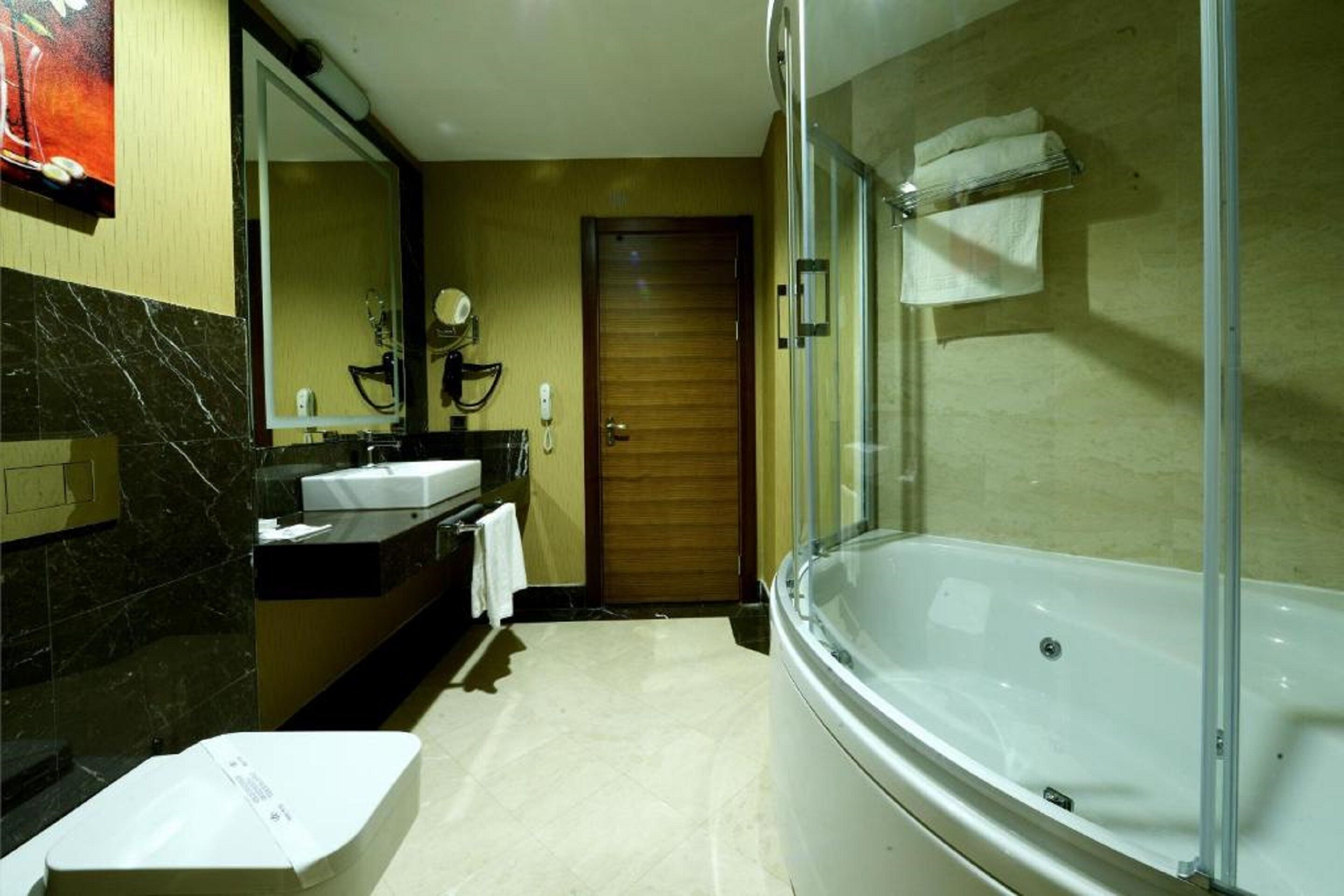 business suite, 1 king bed, jetted tub, city view | bathroom | hair dryer, towels, soap, shampoo