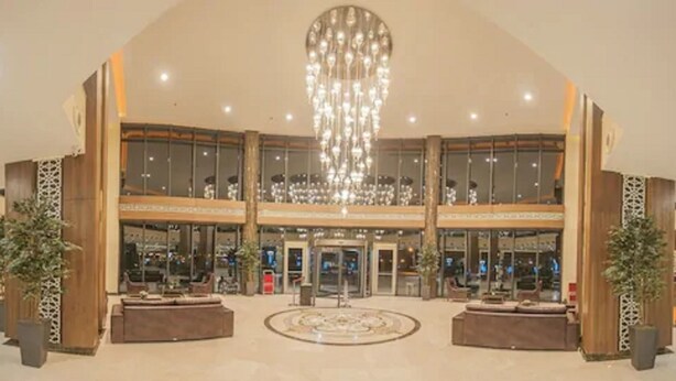 A spacious lobby with a grand chandelier, multiple levels of seating, and a central fountain. - Margi Hotel (Edirne)